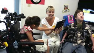 A teacher reads to two students