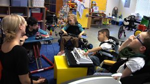 A teacher sitting in a circle with four students